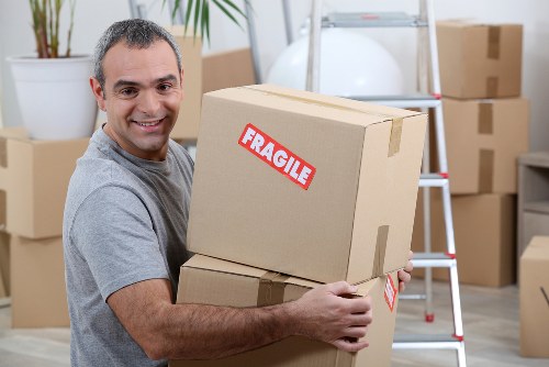Movers handling bulky furniture and boxes for a Winchmore Hill house move