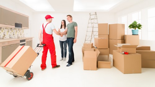 Careful loading of household items into a van for a Winchmore Hill move