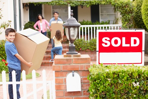 Moving team handling furniture in a residential North London property