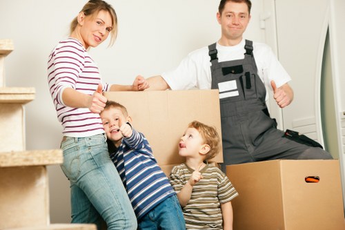 Careful unloading of boxes and furniture at a Winchmore Hill property